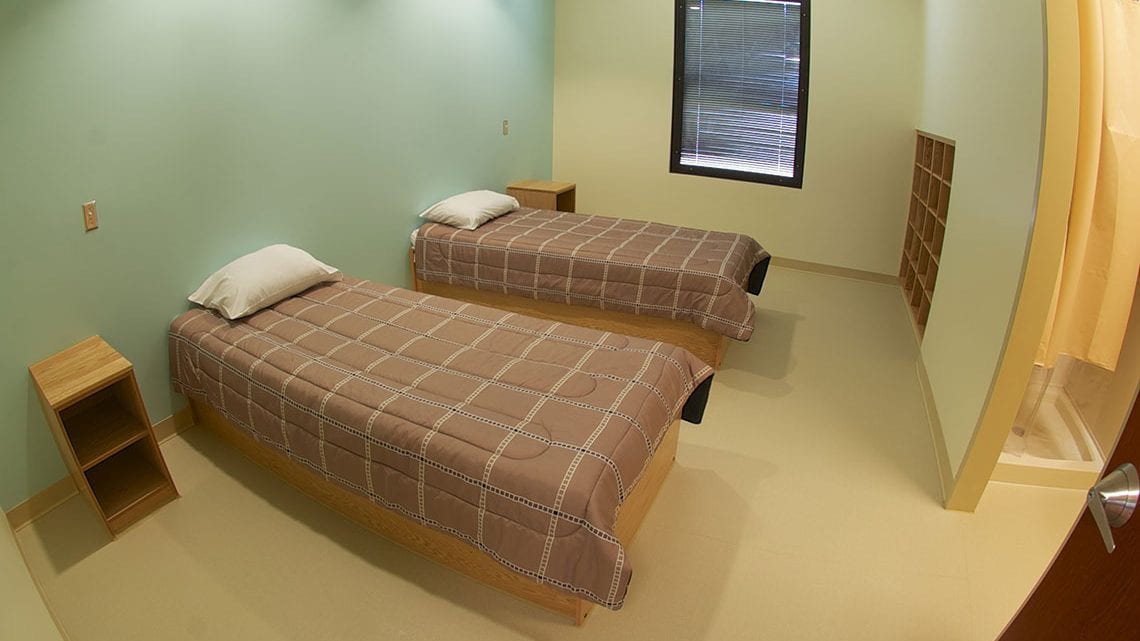 Shared bedroom with two beds and personal storage