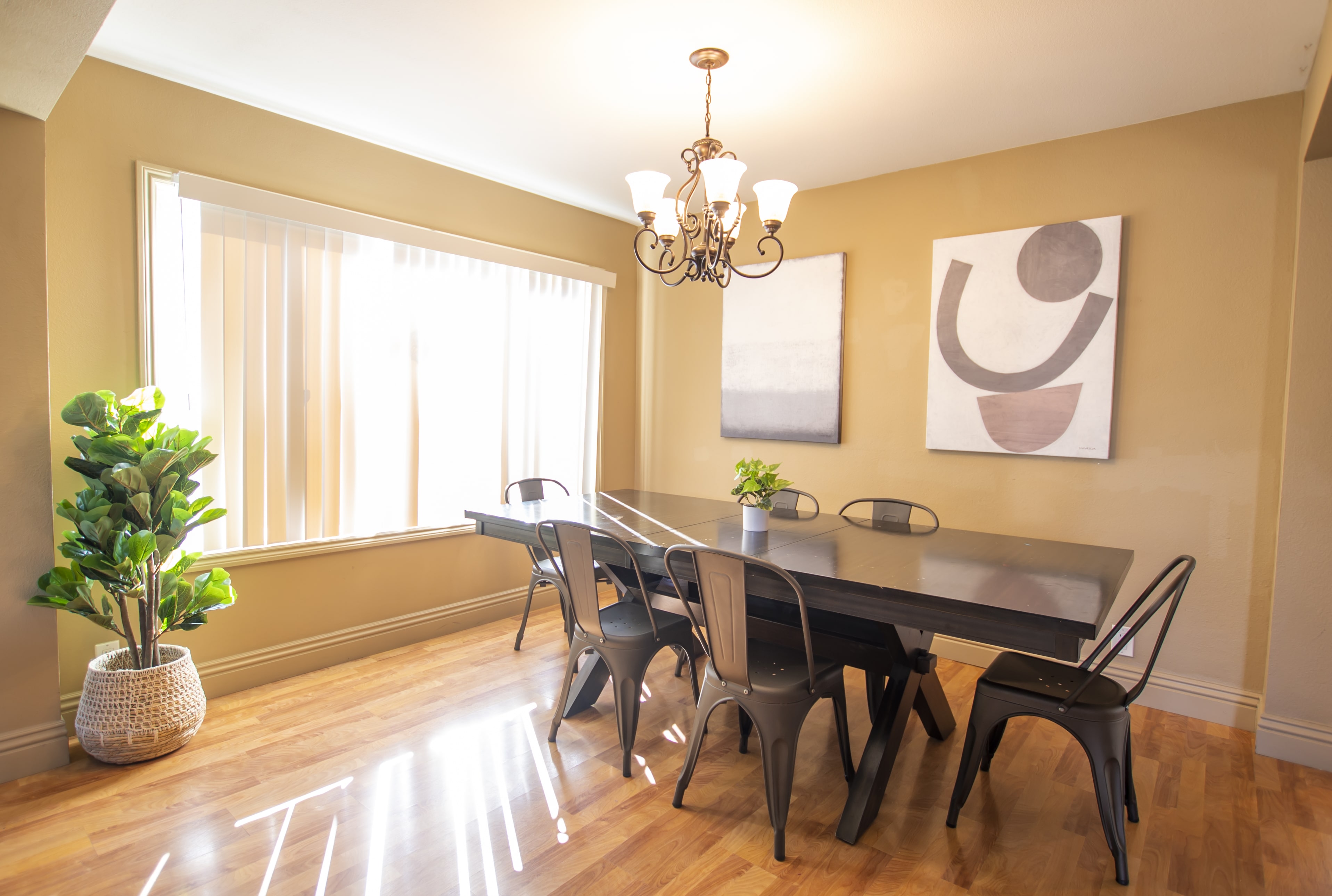 Dining table with six chairs near large window