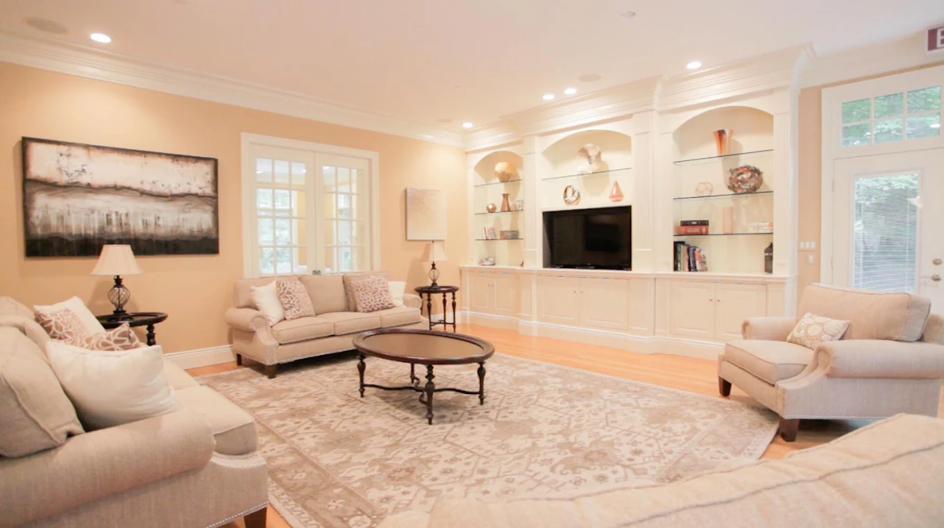 Community living room with sofas and built-in entertainment center