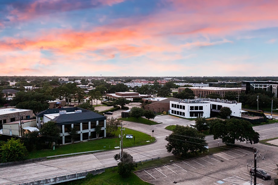 Aerial view of rehab center building surrounded by streets and trees