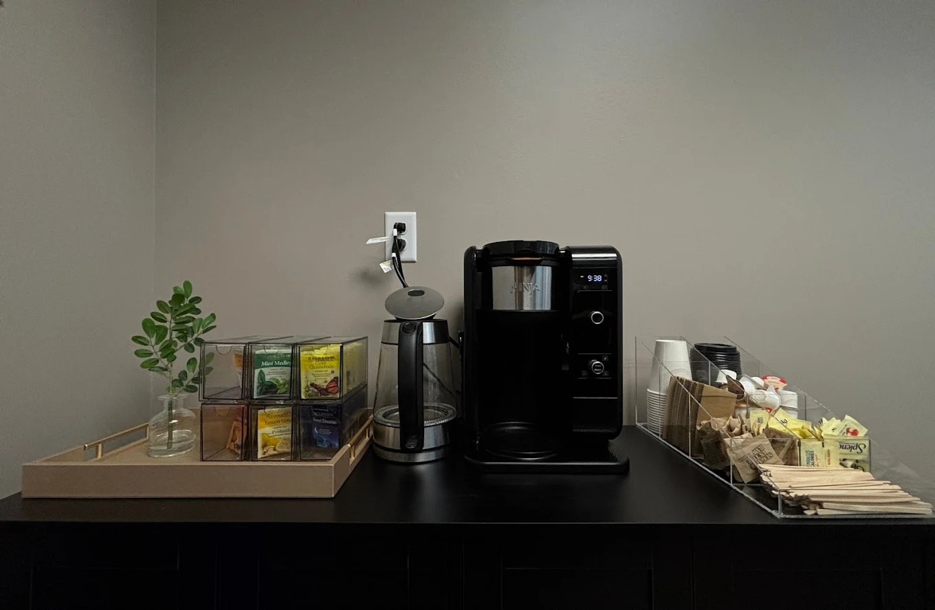 Coffee and tea station with snacks and supplies