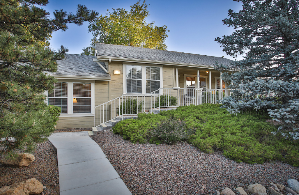 Front view of rehab center with ramp and landscaped path