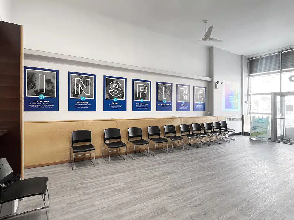 Row of chairs beneath Inspire posters in waiting area