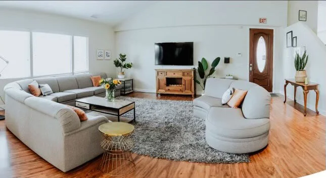Spacious living room with sectional sofa and TV setup