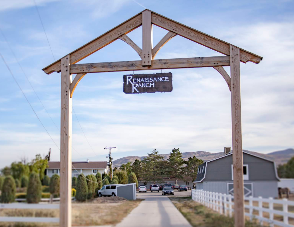 Entrance sign and outdoor grounds at Renaissance Ranch