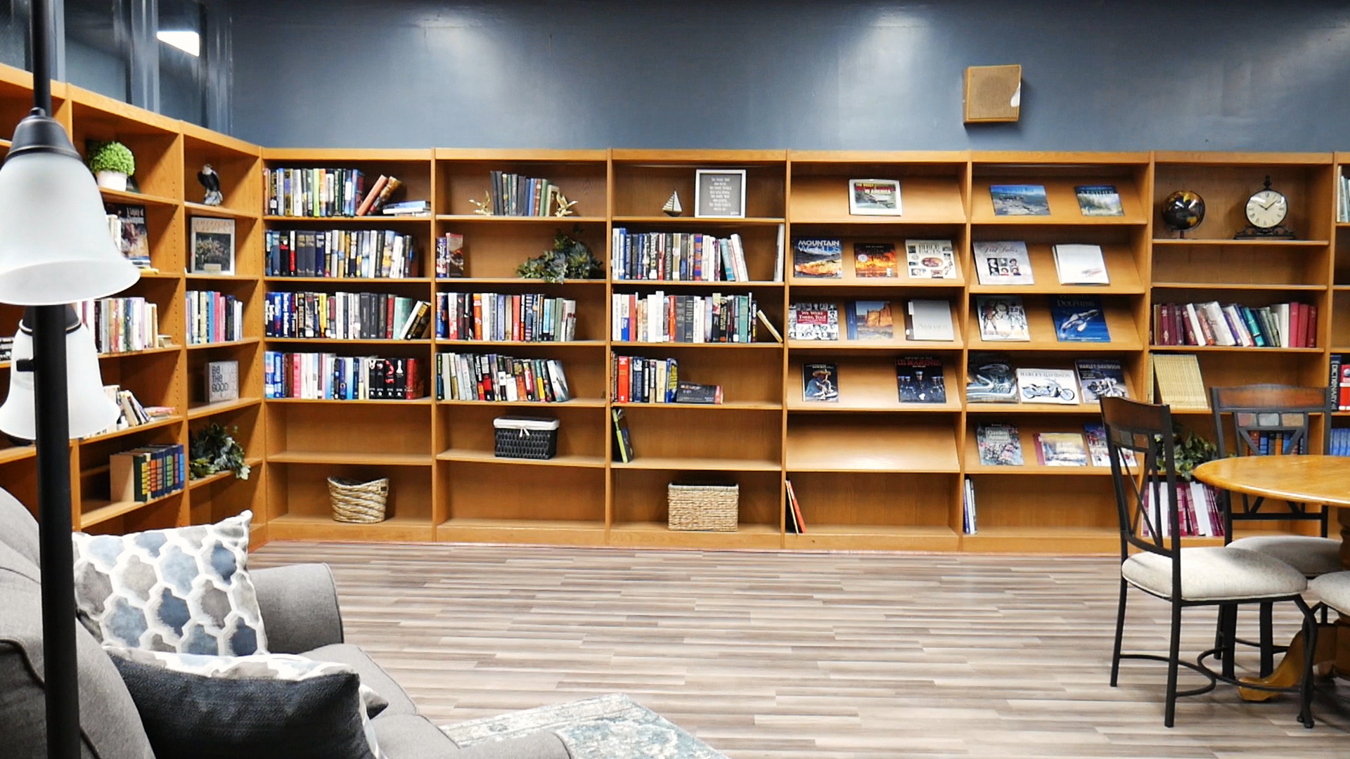 Wall-to-wall bookshelves in bright library lounge