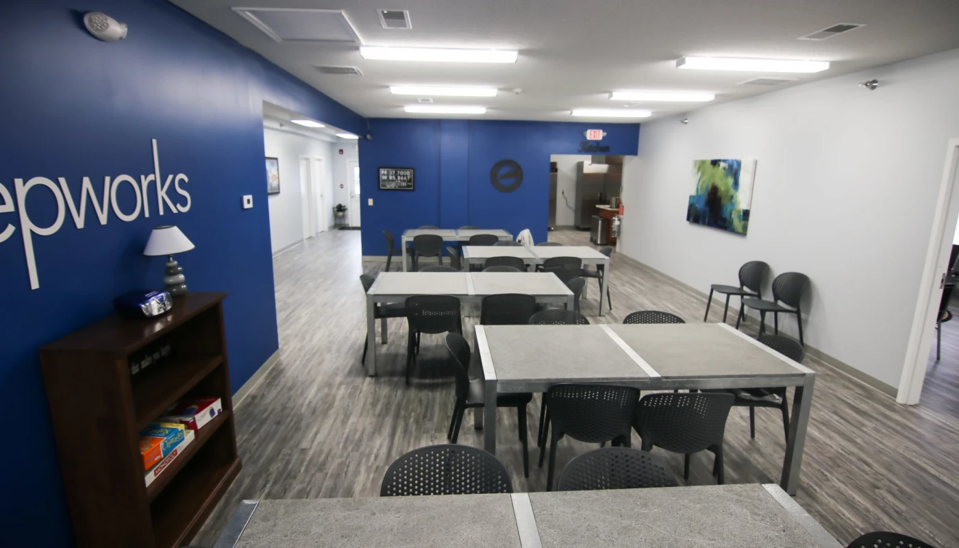 Blue and white meeting room with tables and modern decor