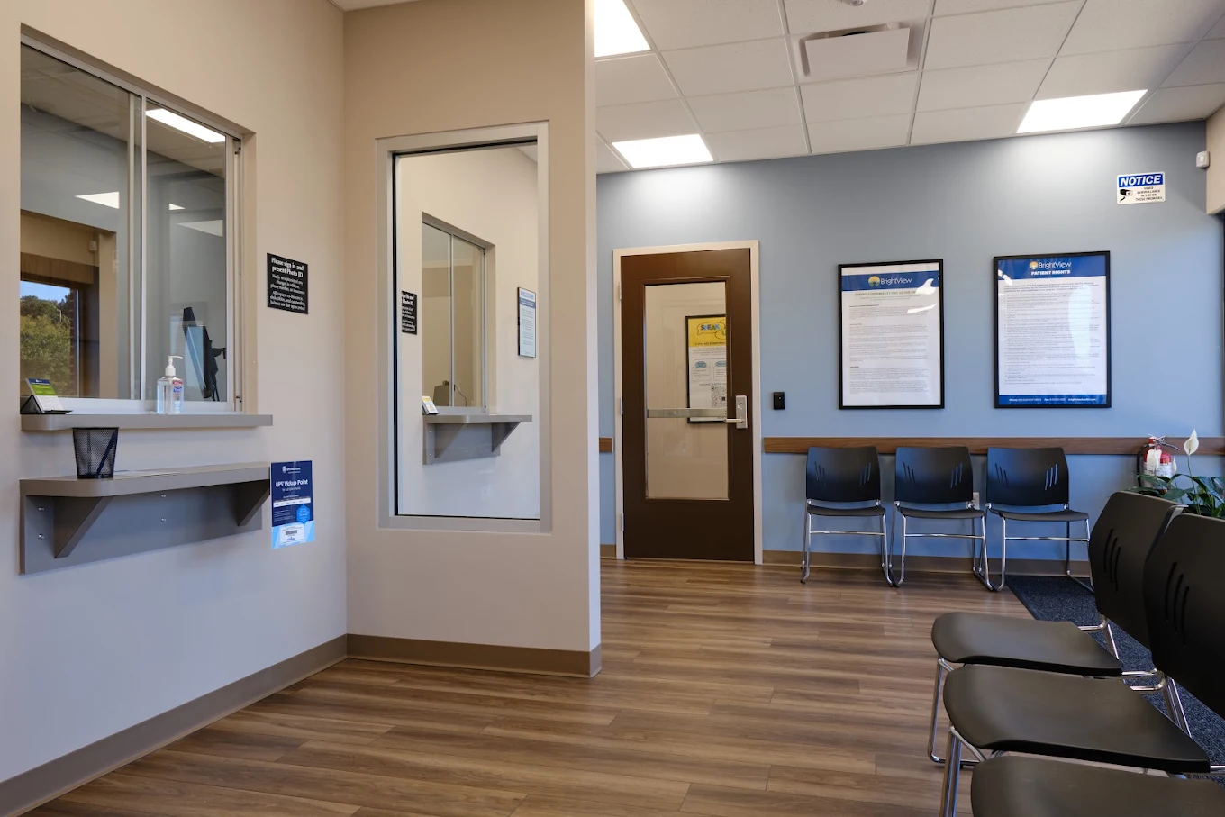 Reception area with check-in windows and waiting chairs