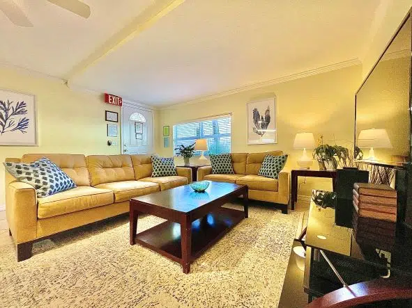 Living room showing a sectional sofa, coffee table, and a window.