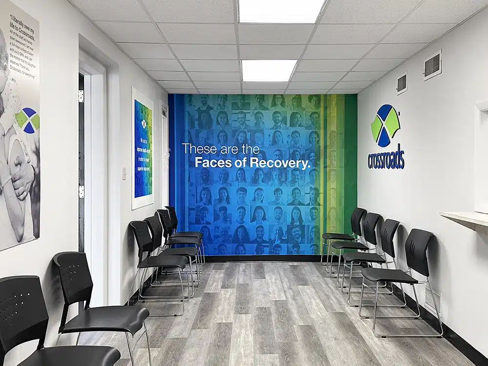 Waiting room with chairs and “Faces of Recovery” wall