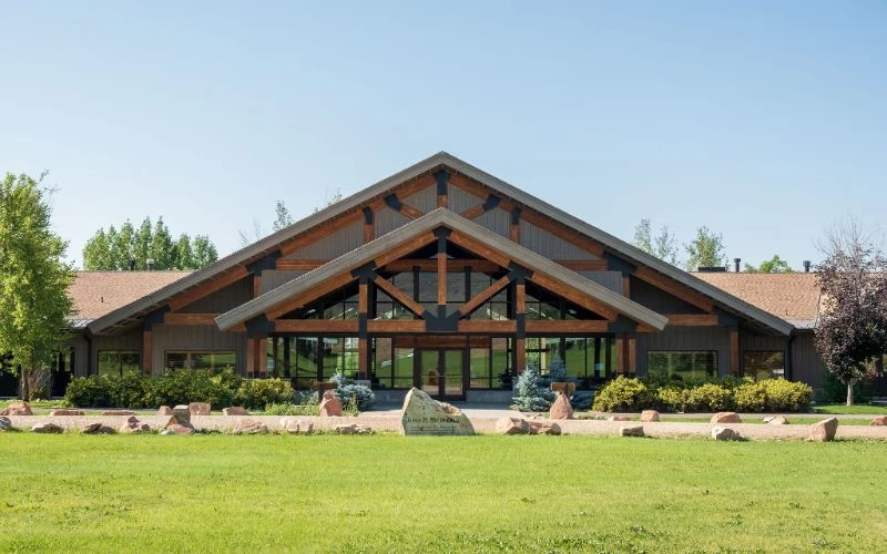 Lodge-style building with tall entry and peaked roof