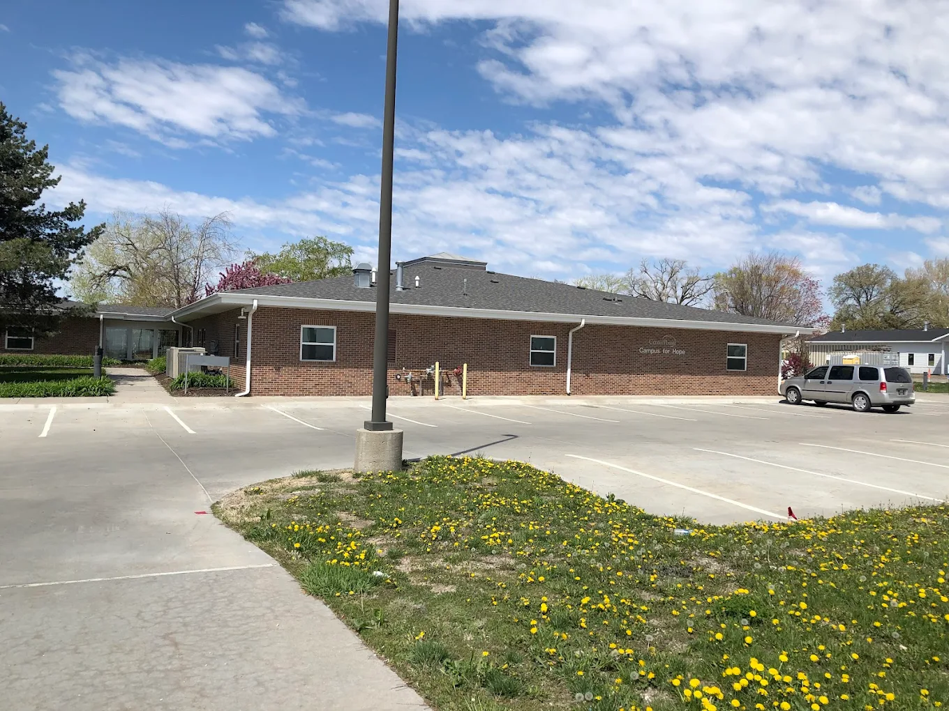 Exterior of brick rehab facility with parking lot