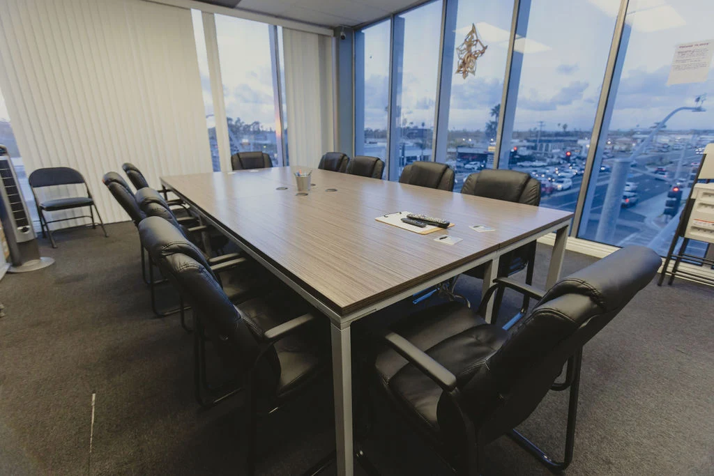 Conference room with large table, chairs, and marina views