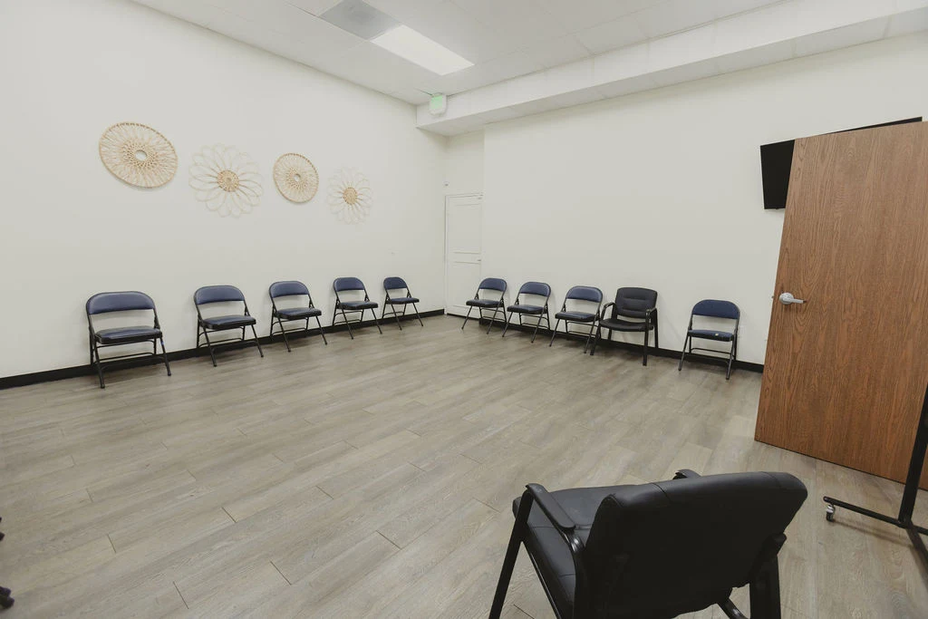 Group therapy room with chairs arranged along the walls