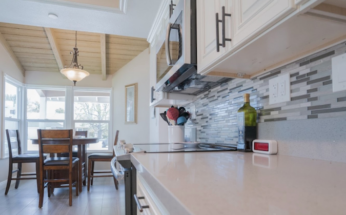 Kitchen with modern backsplash and a view of breakfast nook