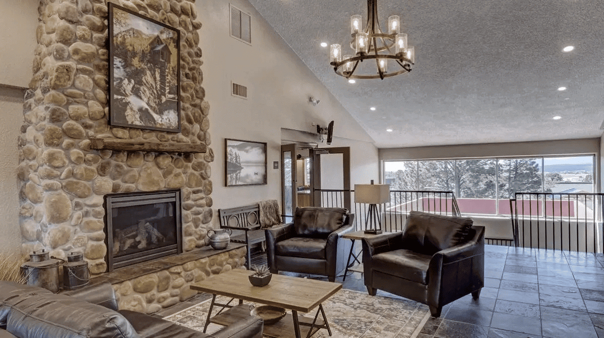 Lounge with  seating, and a fireplace.