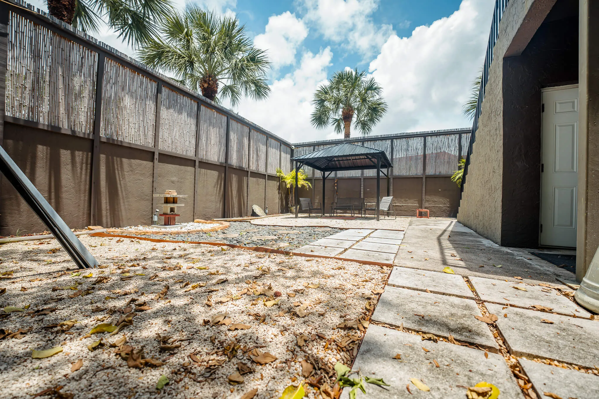 Outdoor courtyard with gazebo and lounge chairs
