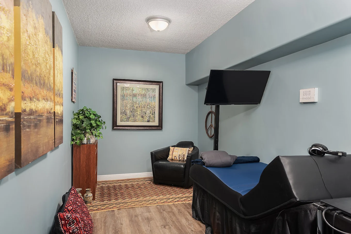 Relaxation room with therapy table and TV screen