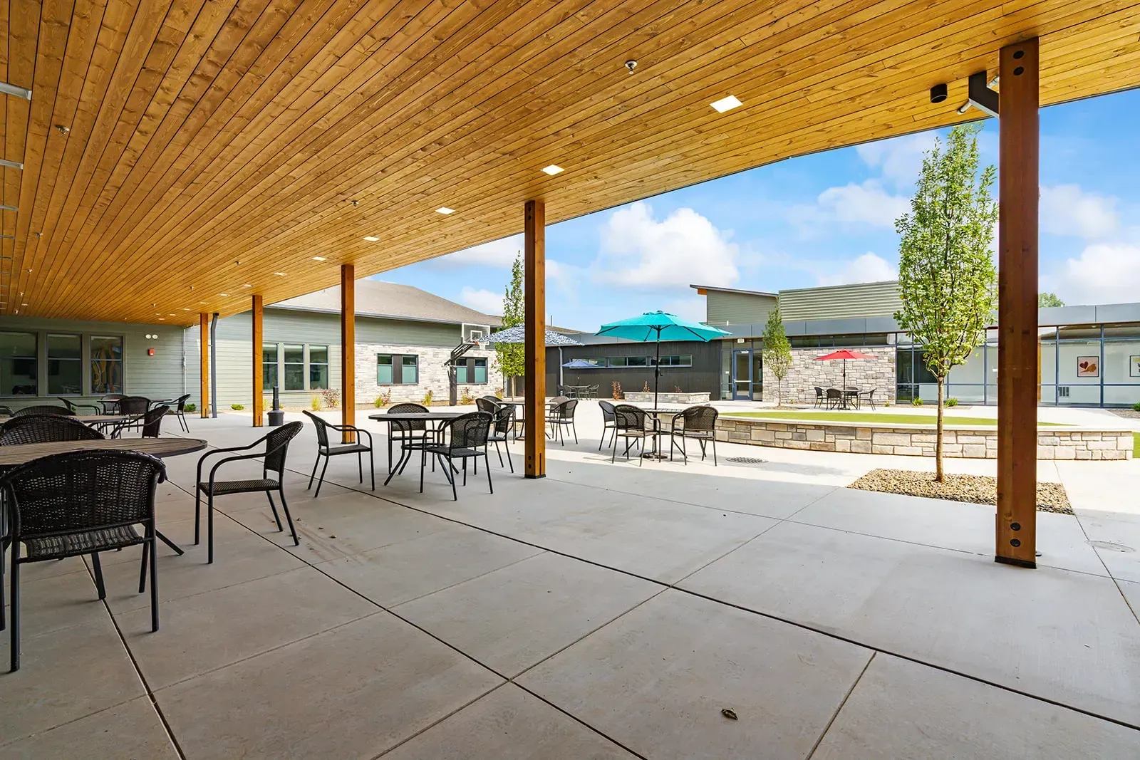 Covered outdoor patio with tables and courtyard seating