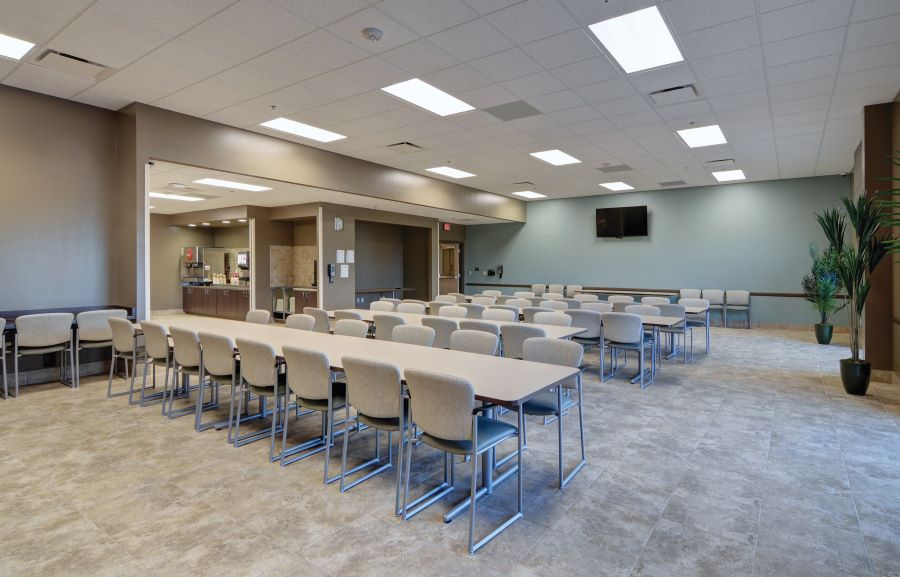 Long dining tables in spacious cafeteria setting