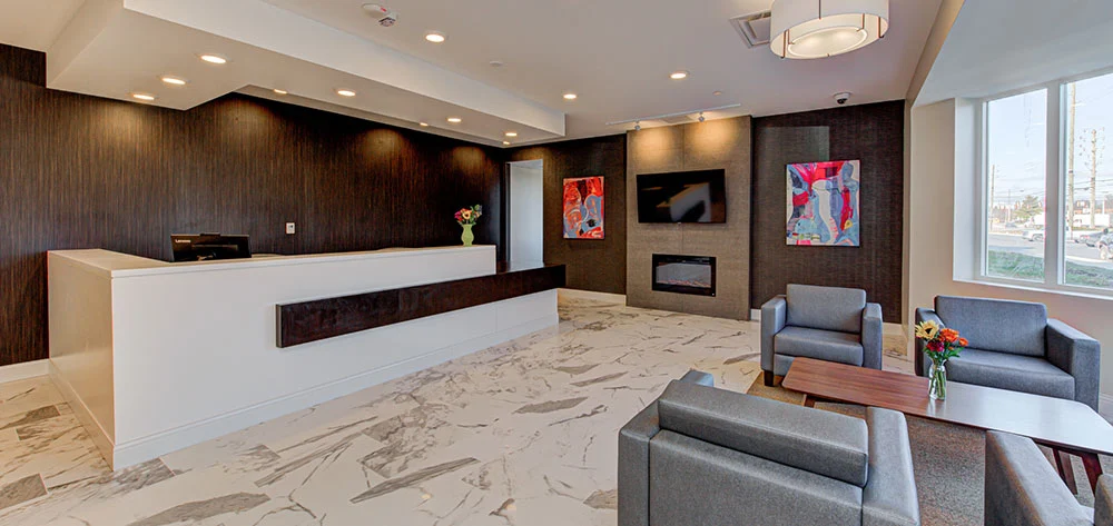 Reception desk with gray seating and wall art