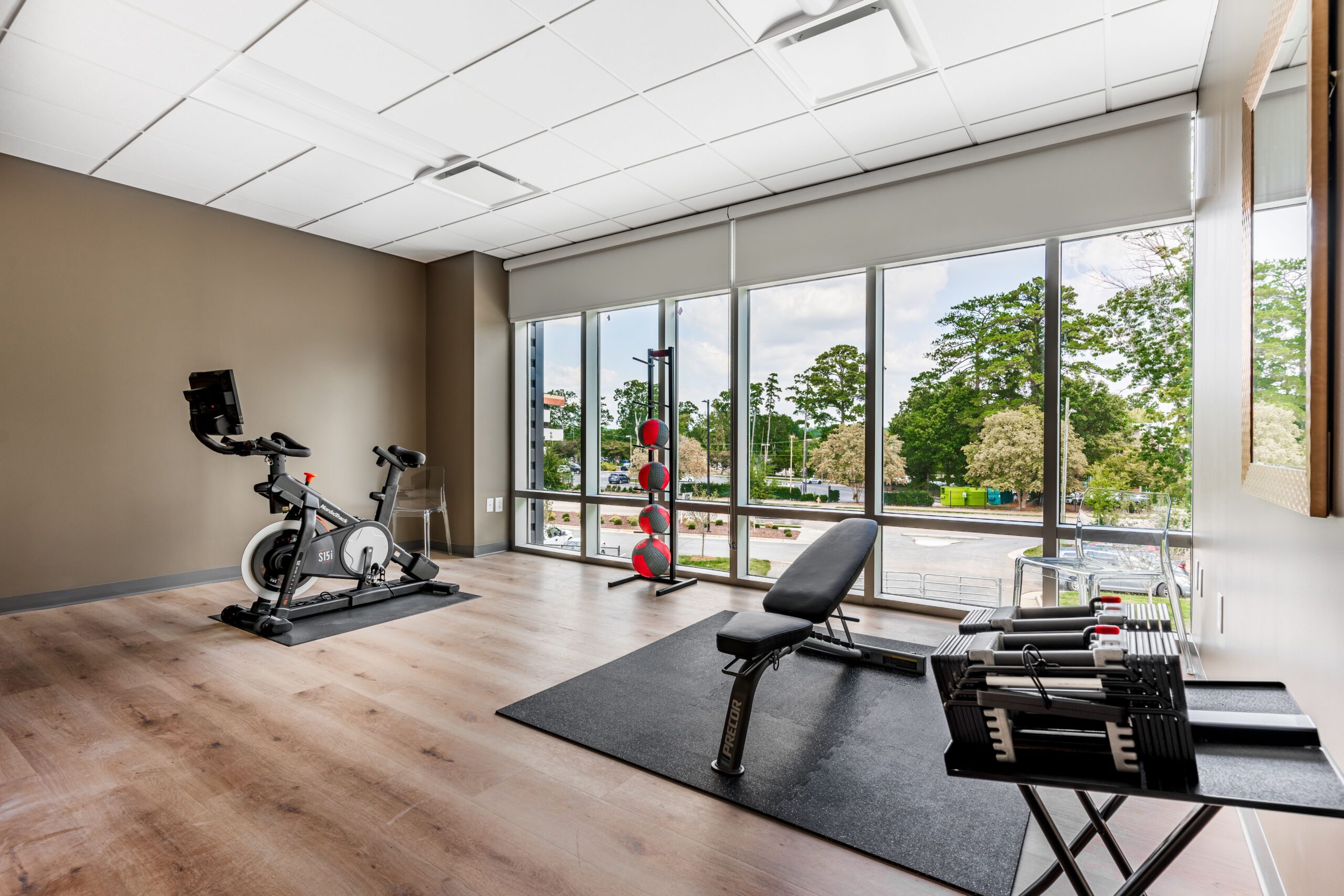 Fitness center with exercise bike, bench, and free weights