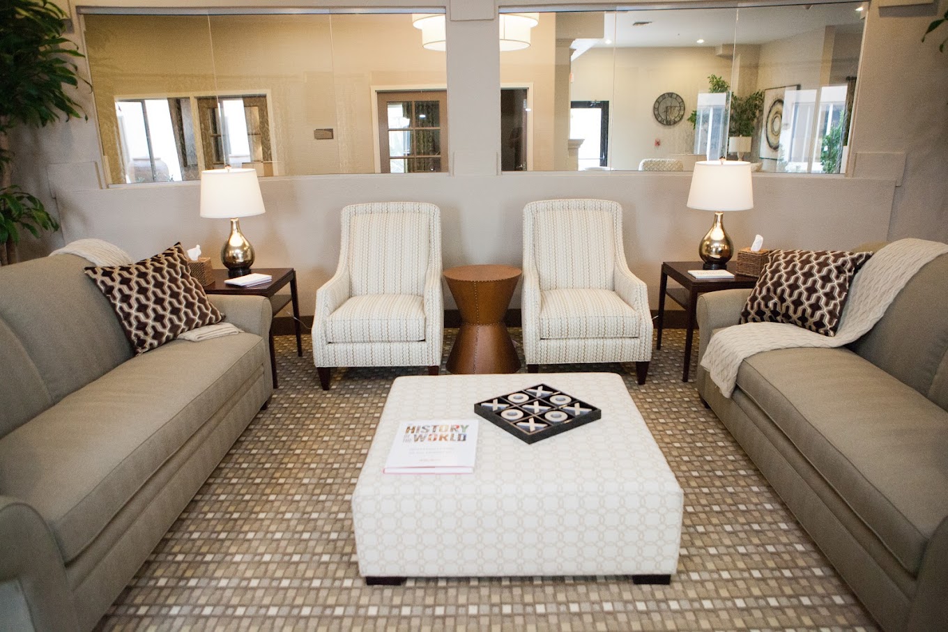 A cozy lounge area with neutral-tone sofas and armchairs