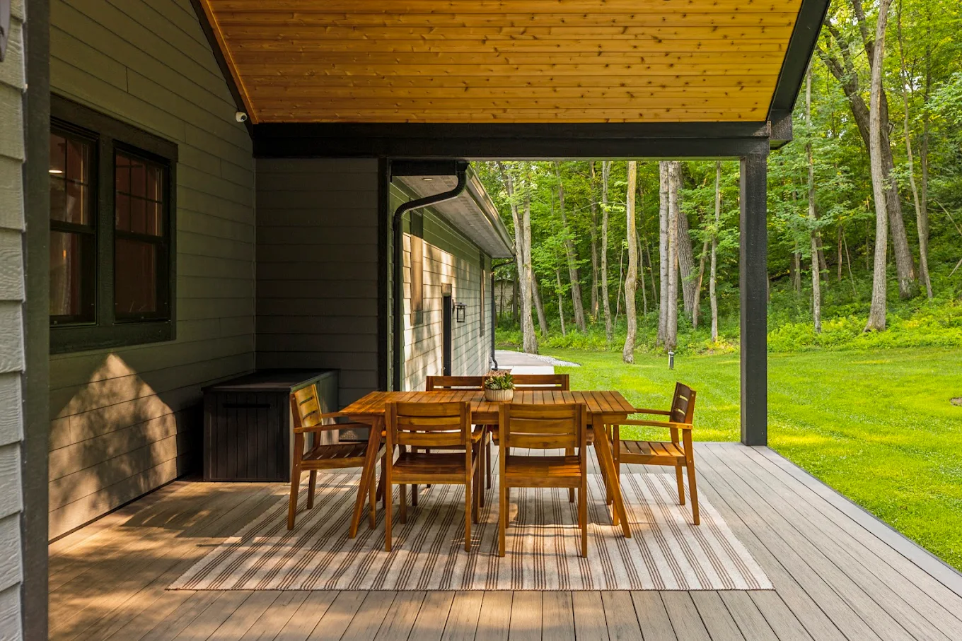 Covered patio with wooden dining table