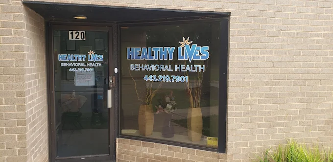 Glass door entrance with Healthy Lives Behavioral Health sign.