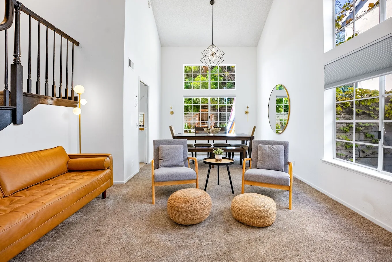 Bright sitting area with sofa, chairs, and dining table