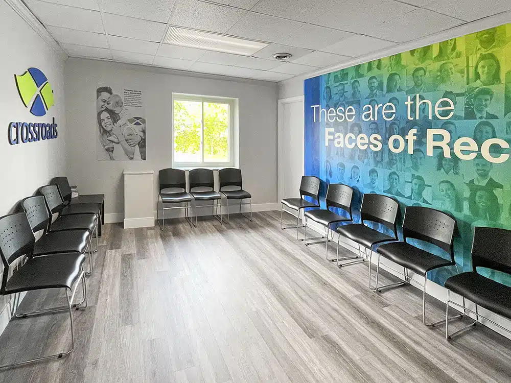 Waiting room with chairs and Faces of Recovery mural