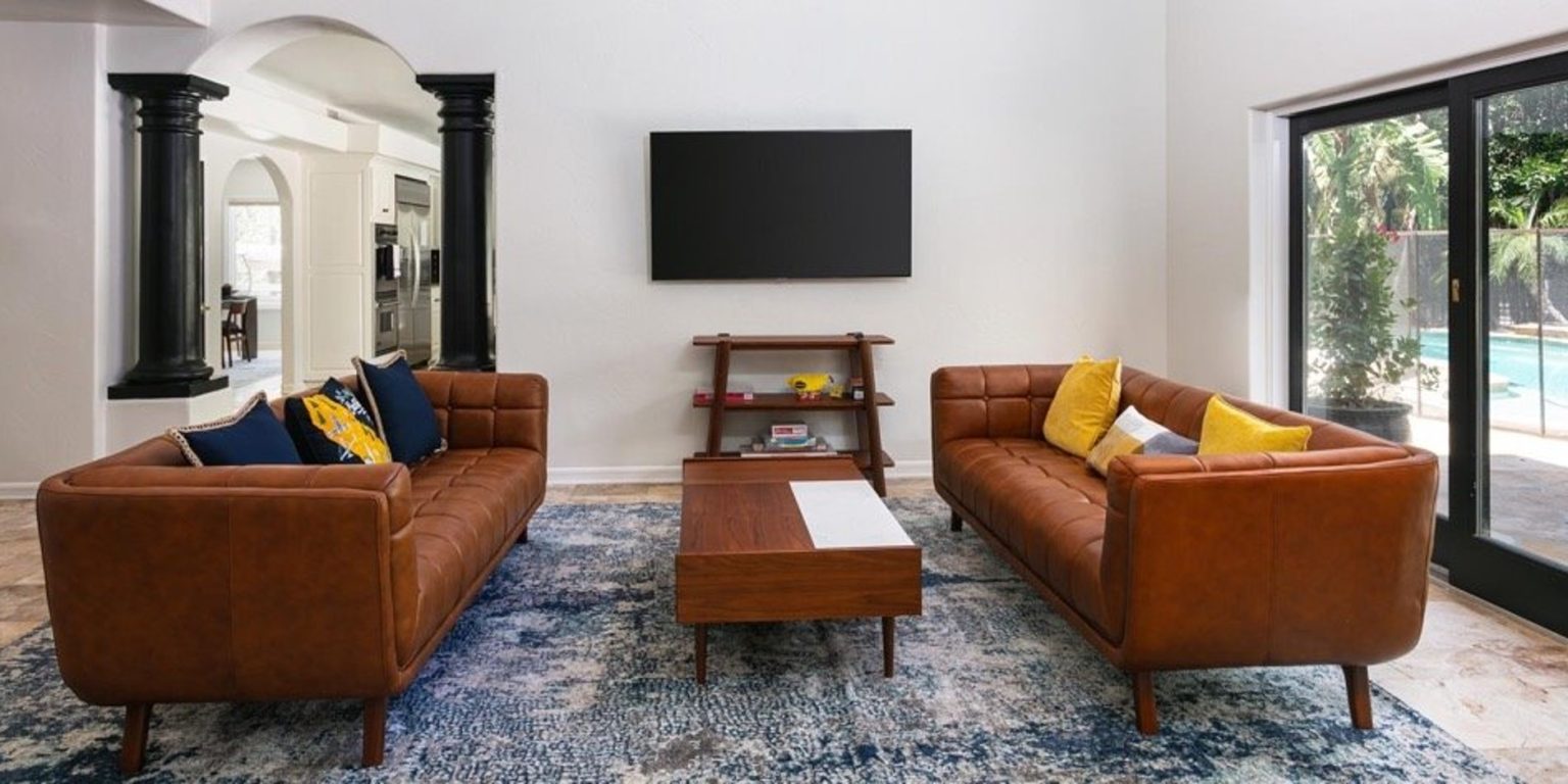 Comfortable family room with leather sofas and television