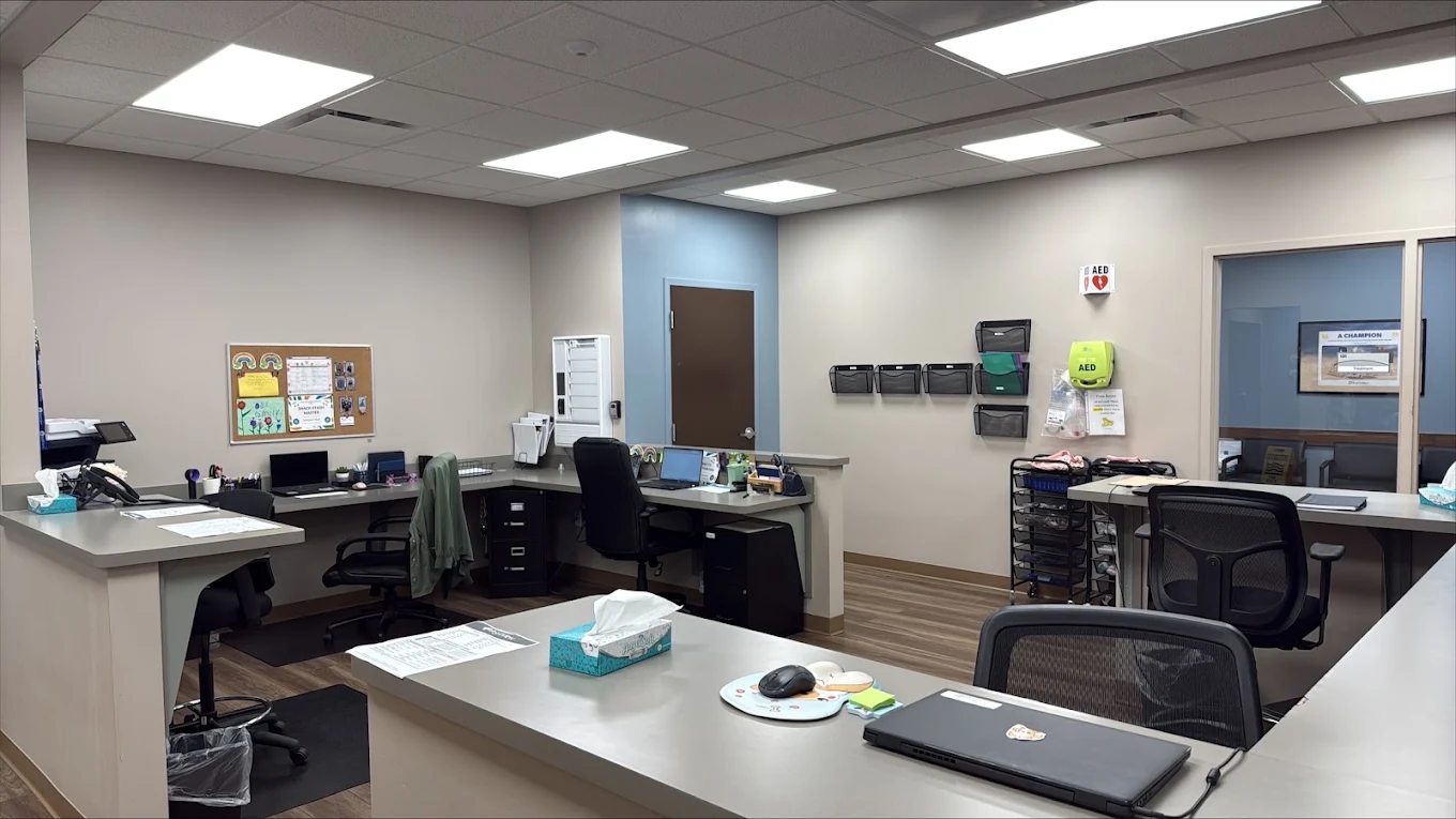 Nurses station at BrightView Health Marion with multiple computer workstations, wraparound counters, office chairs, medical storage, and AED equipment