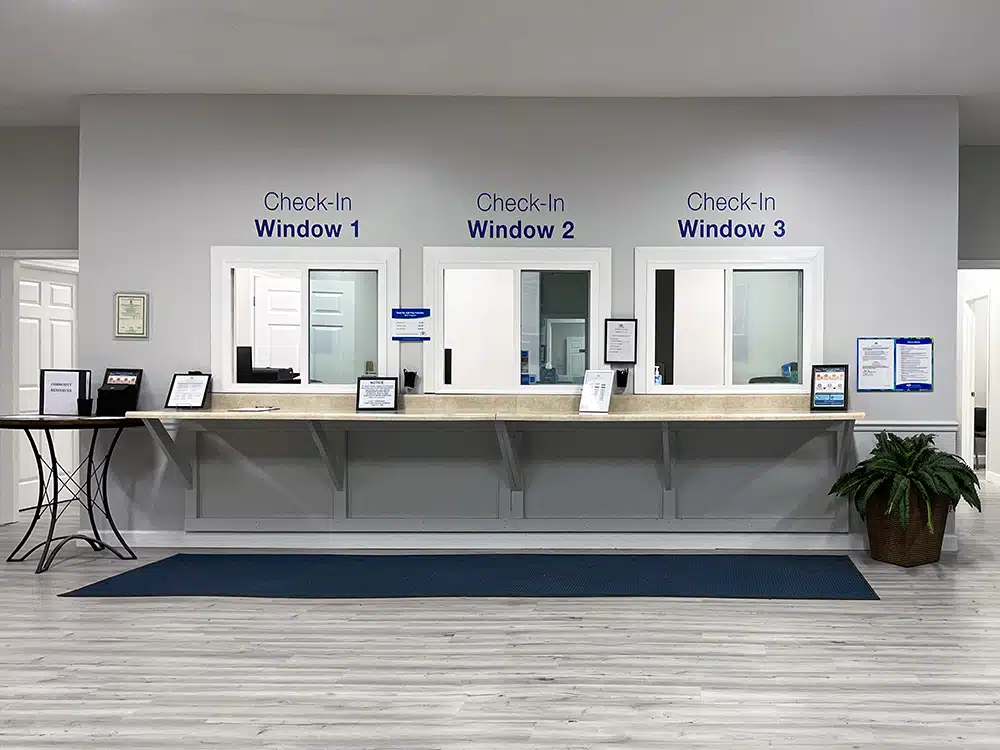 Reception area with three check-in windows and counter