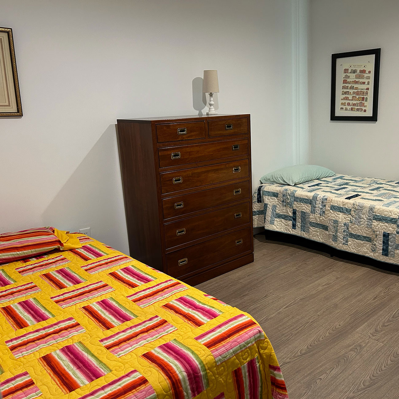 Shared bedroom with twin beds and dresser at women's recovery home