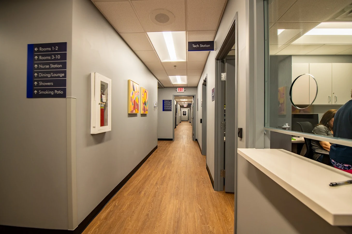 Clinic hallway with direction signs and reception window