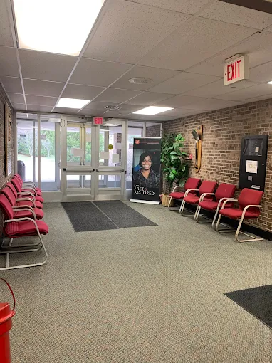 Lobby with red chairs and glass entrance doors