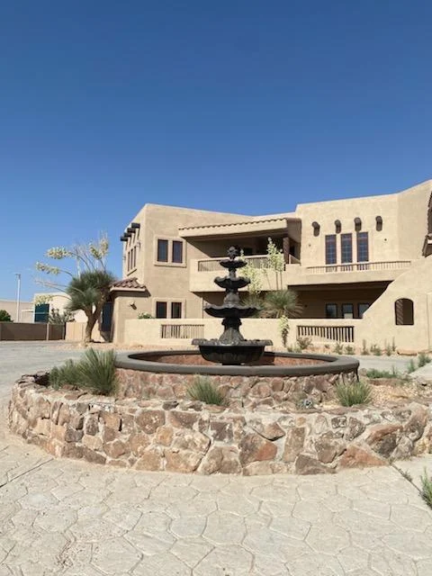 Outdoor fountain in front of a Southwestern-style residential building at Icarus Behavioral Health Albuquerque