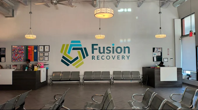 Lobby with reception desk, chairs, and Fusion Recovery logo