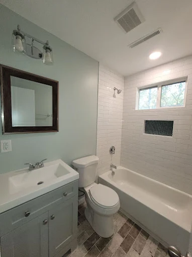 Modern bathroom with sink, toilet, and bathtub