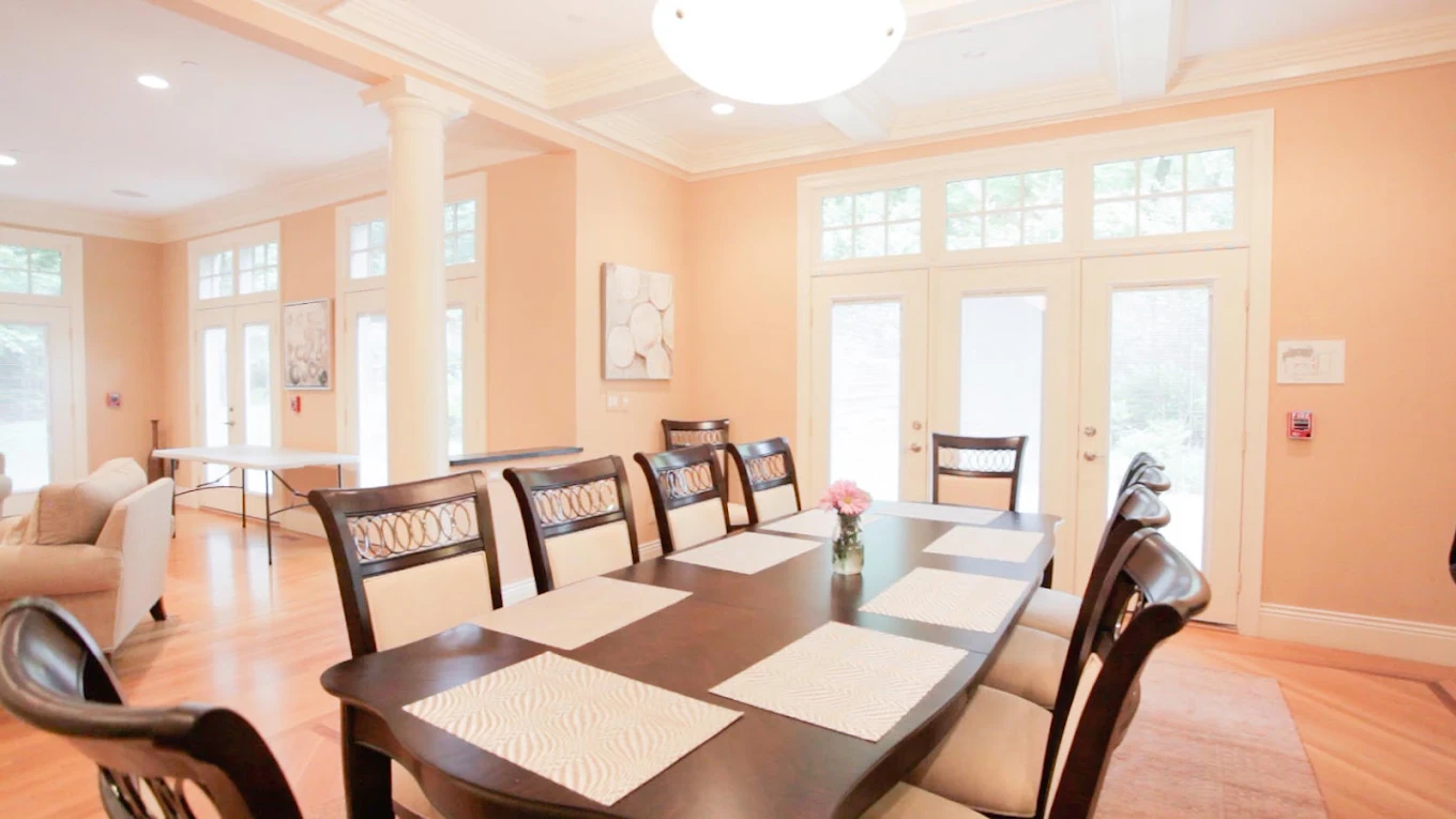 Spacious dining room with large table and natural light