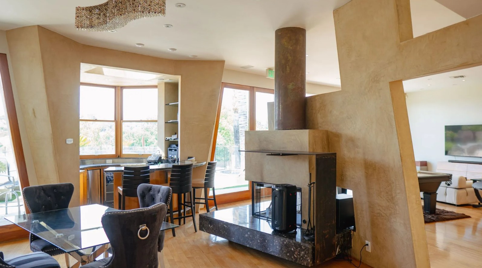 Open-concept great room with fireplace and dining area