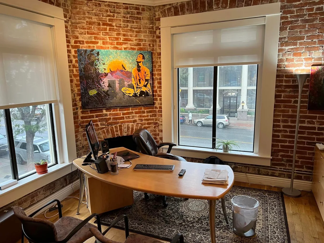 Private office with desk and exposed brick walls