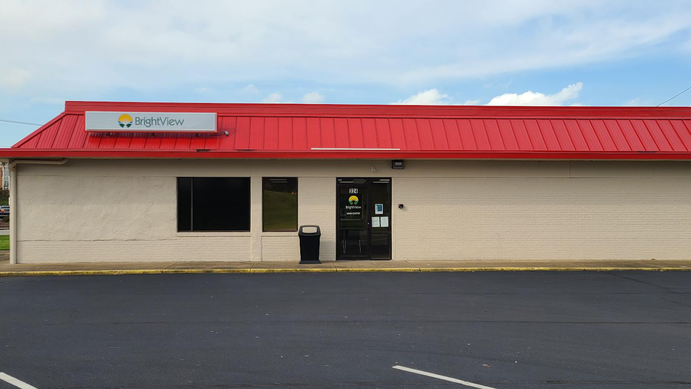 Front exterior of BrightView Health Marietta with a red metal roof, BrightView sign, main entrance, dark windows, and paved parking area