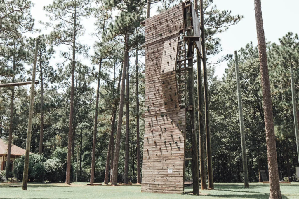 Tall ropes course surrounded by pine trees