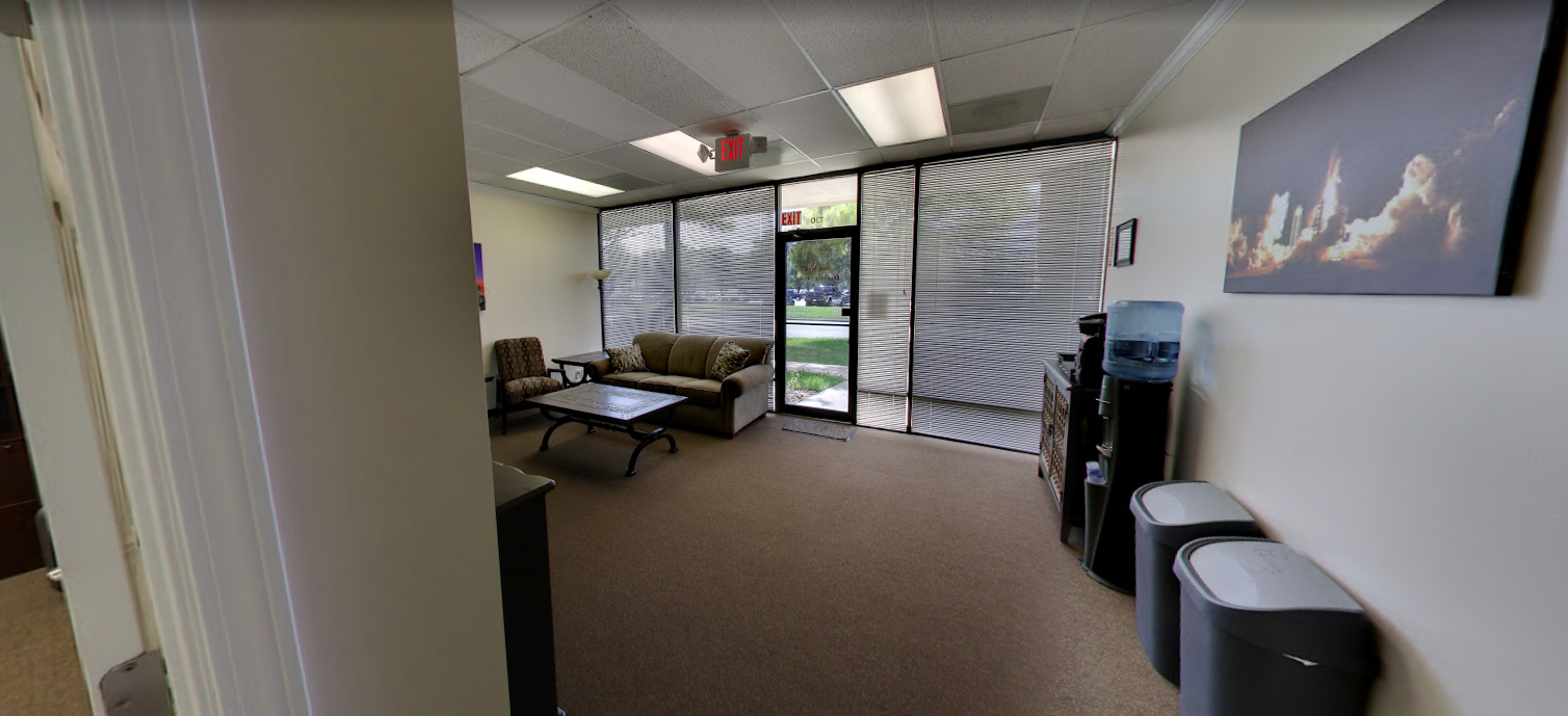 Waiting area with sofas, blinds, and water dispenser