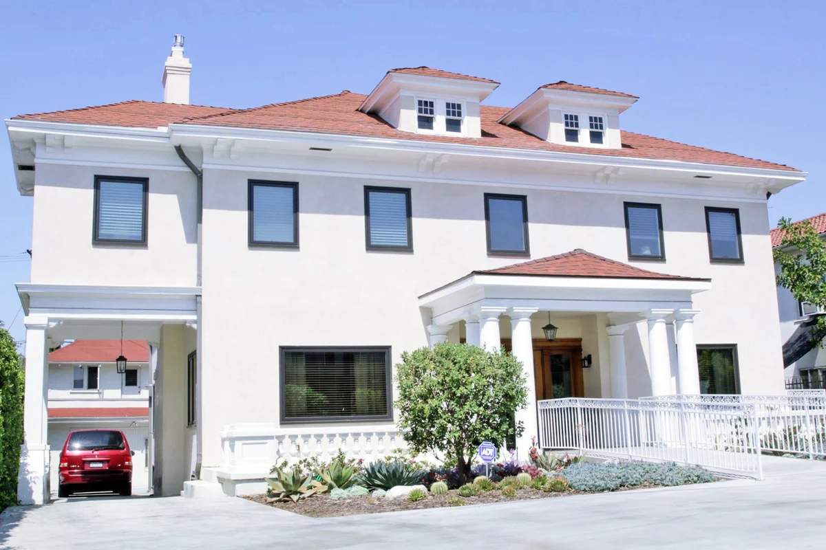Front view of Friendly House Los Angeles with white columns and red roof