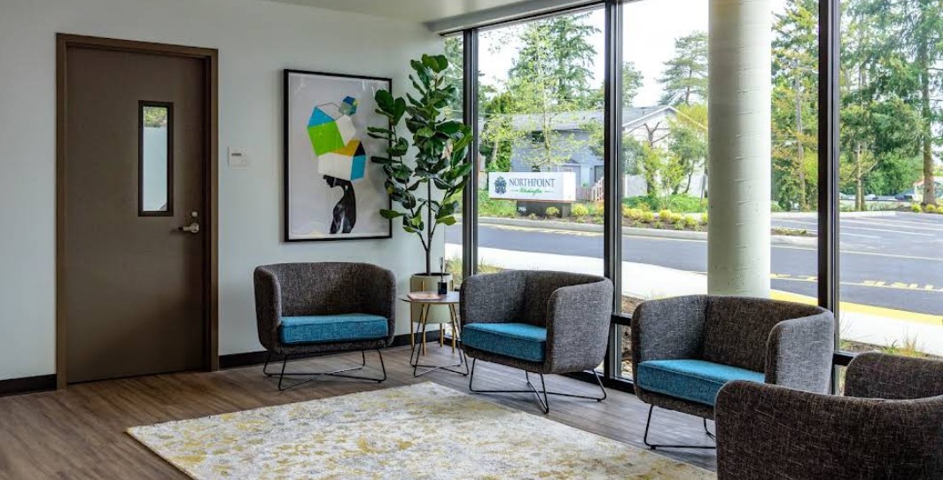 Bright waiting area with modern chairs and large windows