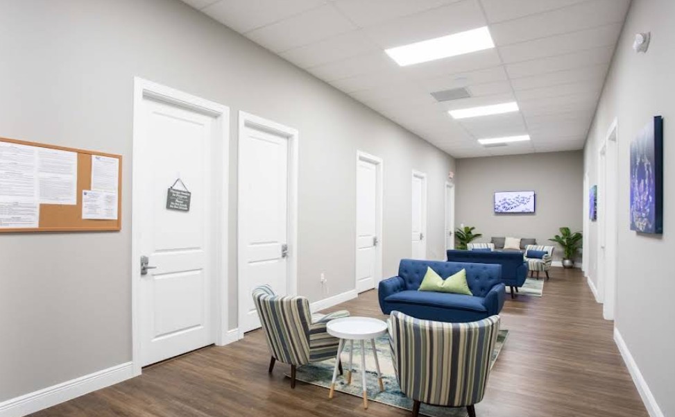 Client lounge area with seating along treatment offices
