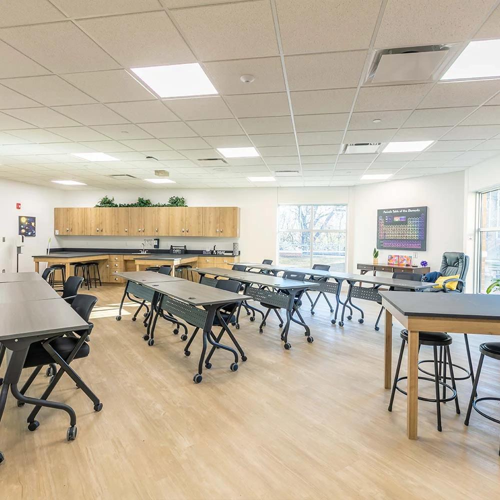 Modern classroom with movable desks and windows